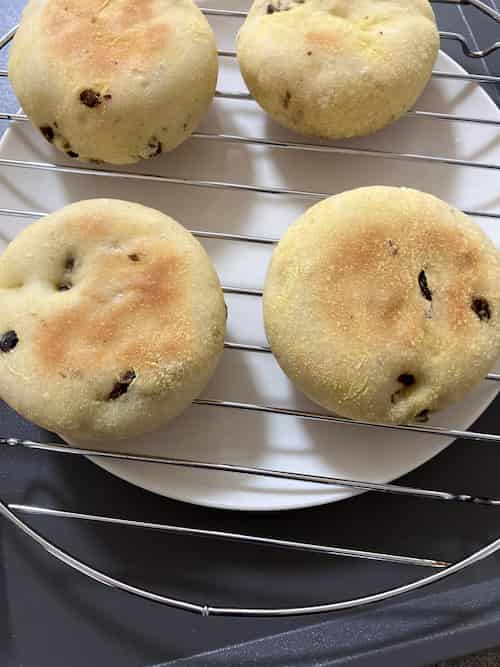 焼き上がった、ちょっと狐色になっているイングリッシュマフィン4個が、網の上にのっているところ。